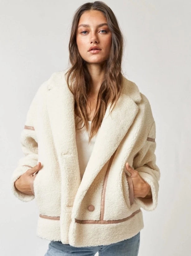 Falling Faux Fur Jacket Faux Fur Jacket PU Binding Detail Collared Neckline Button Up Color: Off White Stay warm and snug with this Falling Faux Fur Jacket. Crafted with a soft and luxurious faux fur material, this jacket is sure to provide comfort and style for any occasion. Its unique design offers a cozy fit, making it perfect for those cold winter days.