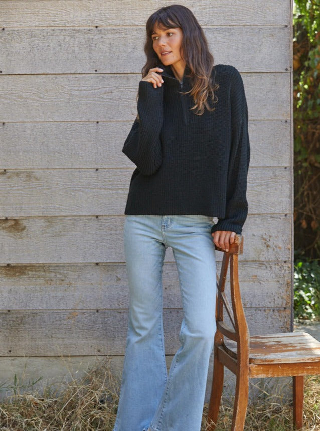 On The Boardwalk Sweater Knitted Sweater Quarter zip Turtleneck Specs/dimensions: HPS Length: (S) 20 1/4", (M) 20 3/4", (L) 21 1/4" Chest: (S) 21 1/4", (M) 22 1/4", (L) 23 1/4" Sweep: (S) 20 3/4", (M) 21 3/4", (L) 22 3/4" Sleeve Length: (S) 17", (M) 17 1/4", (L) 17 1/2" 94% Acrylic, 6% Nylon Color: Black Stay warm and stylish in this quarter zip sweater. Its soft, lightweight fabric makes it ideal for breezy beach days, while th