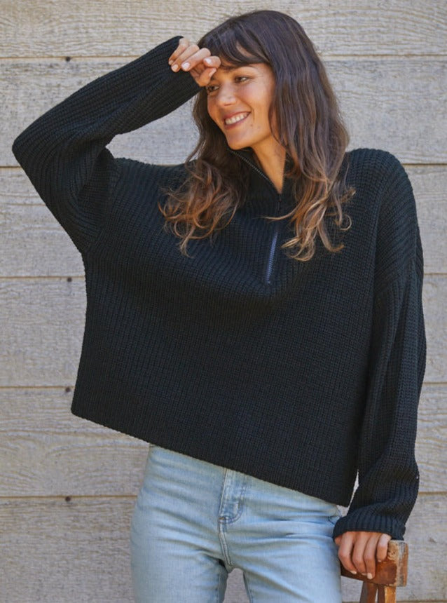 On The Boardwalk Sweater Knitted Sweater Quarter zip Turtleneck Specs/dimensions: HPS Length: (S) 20 1/4", (M) 20 3/4", (L) 21 1/4" Chest: (S) 21 1/4", (M) 22 1/4", (L) 23 1/4" Sweep: (S) 20 3/4", (M) 21 3/4", (L) 22 3/4" Sleeve Length: (S) 17", (M) 17 1/4", (L) 17 1/2" 94% Acrylic, 6% Nylon Color: Black Stay warm and stylish in this quarter zip sweater. Its soft, lightweight fabric makes it ideal for breezy beach days, while th
