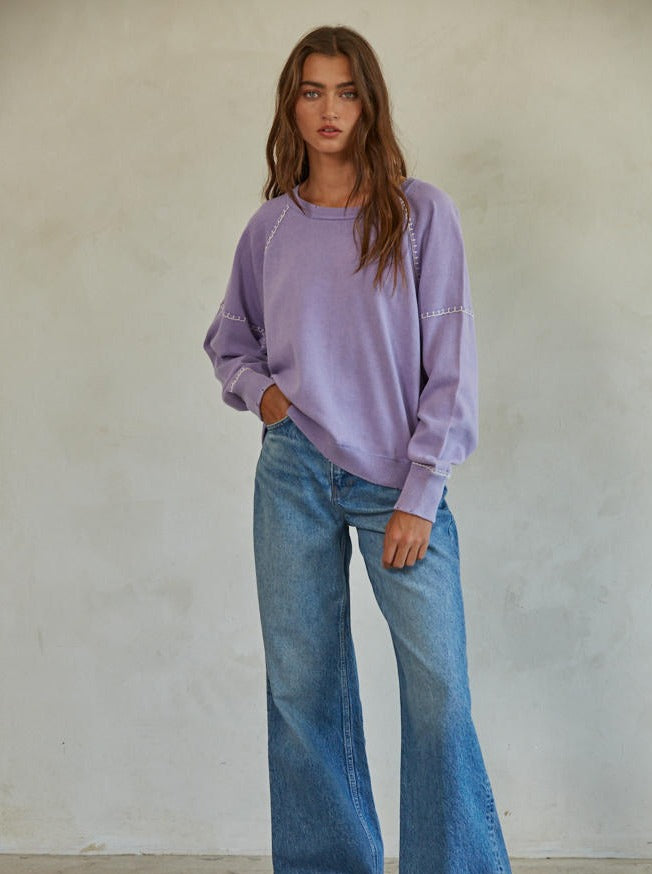 Franky Sweater Cotton Knit Round Neck Long Sleeve Stitch Detail Sweater Top 100% Cotton Color: Pale Green and Dark Lavender The Franky Sweater features a classic crew neck design that is timeless and versatile. Its lightweight, breathable fabric makes it perfect for any season and occasion. The sweater is durable making it a great addition to any wardrobe.