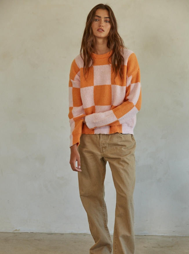 Call You Mine Pullover Knit Polyester Sweater Gingham Print Crew Neck Long Sleeve Pullover Top 100% Polyester Color: Orange This Call You Mine Pullover features a timeless checkered print design. Crafted with quality materials and stitching, this cardigan is sure to deliver comfort and style for years to come. Add a classic touch to your wardrobe with this stylish cardigan.