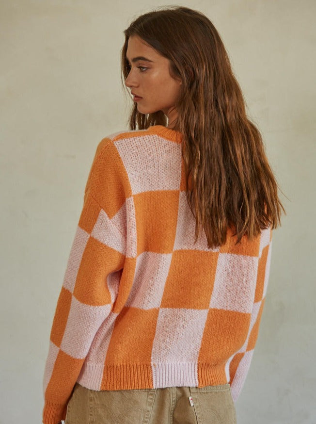Call You Mine Pullover Knit Polyester Sweater Gingham Print Crew Neck Long Sleeve Pullover Top 100% Polyester Color: Orange This Call You Mine Pullover features a timeless checkered print design. Crafted with quality materials and stitching, this cardigan is sure to deliver comfort and style for years to come. Add a classic touch to your wardrobe with this stylish cardigan.