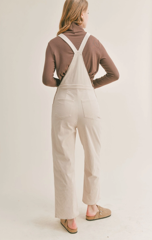 Nomad Corduroy Overalls Corduroy overalls Pockets 100% Polyester Color: Cream The Nomad Corduroy Overalls will keep you stylish and comfortable all day long. Made from a durable corduroy fabric, these overalls are perfect for everyday wear. They provide a great combination of both breathability and protection from the elements. With a timeless silhouette, they are sure to become a staple in your wardrobe.