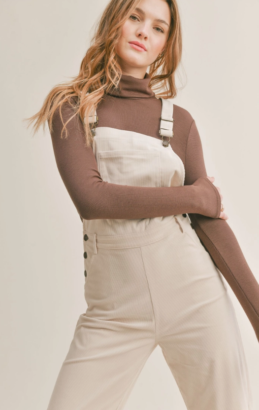 Nomad Corduroy Overalls Corduroy overalls Pockets 100% Polyester Color: Cream The Nomad Corduroy Overalls will keep you stylish and comfortable all day long. Made from a durable corduroy fabric, these overalls are perfect for everyday wear. They provide a great combination of both breathability and protection from the elements. With a timeless silhouette, they are sure to become a staple in your wardrobe.
