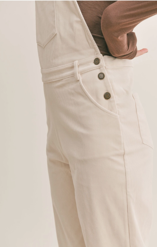 Nomad Corduroy Overalls Corduroy overalls Pockets 100% Polyester Color: Cream The Nomad Corduroy Overalls will keep you stylish and comfortable all day long. Made from a durable corduroy fabric, these overalls are perfect for everyday wear. They provide a great combination of both breathability and protection from the elements. With a timeless silhouette, they are sure to become a staple in your wardrobe.