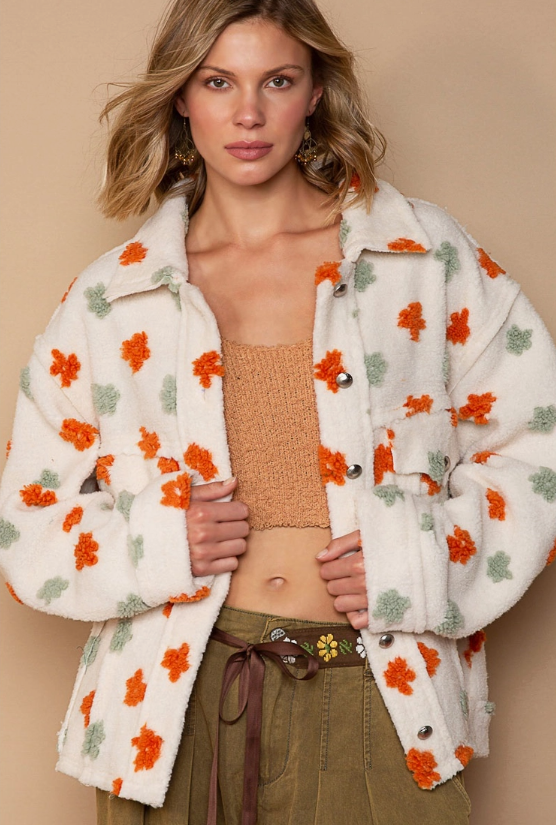 Be fashion forward with the Happy Days Button Down Floral Fleece. With a floral print and a super soft fleece, this stylish button-up jacket is perfect for wearing in cool weather. Comfortably warm and one-of-a-kind, you'll love this unique piece.