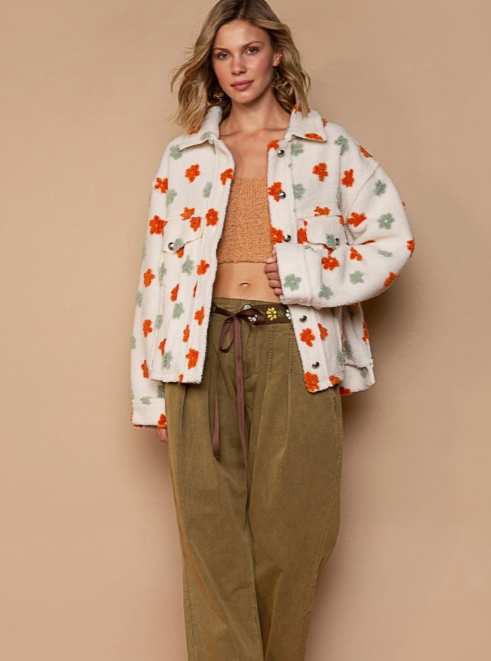 Be fashion forward with the Happy Days Button Down Floral Fleece. With a floral print and a super soft fleece, this stylish button-up jacket is perfect for wearing in cool weather. Comfortably warm and one-of-a-kind, you'll love this unique piece.