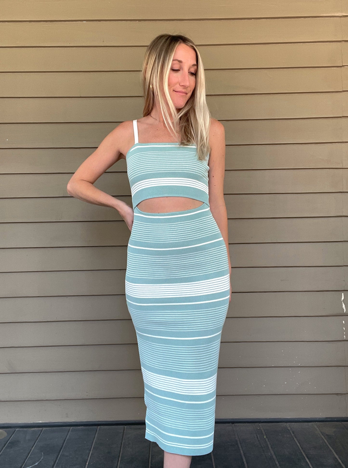 Striped Knit Midi Dress Adjustable spaghetti strap Striped bodycon sweater knit midi dress Front cut out One side slit detail 70% Viscose, 30% Polyester Color: Sea Green The Striped Knit Midi Dress is a timeless wardrobe staple. It features a striped design in a classic midi length that looks great on any body type. The lightweight knit fabric ensures comfort and breathability, making this dress both stylish and practical.