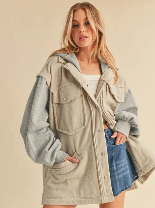 Irene Hooded Jacket  Two toned jacket Button Up Pocket Details Hood 100% Polyester Color: Bone/Heather Gray Irene Jacket features a hood and button fastening, warm for a chilly day. The newness of the piece will turn heads and is crafted in built-to-last material.