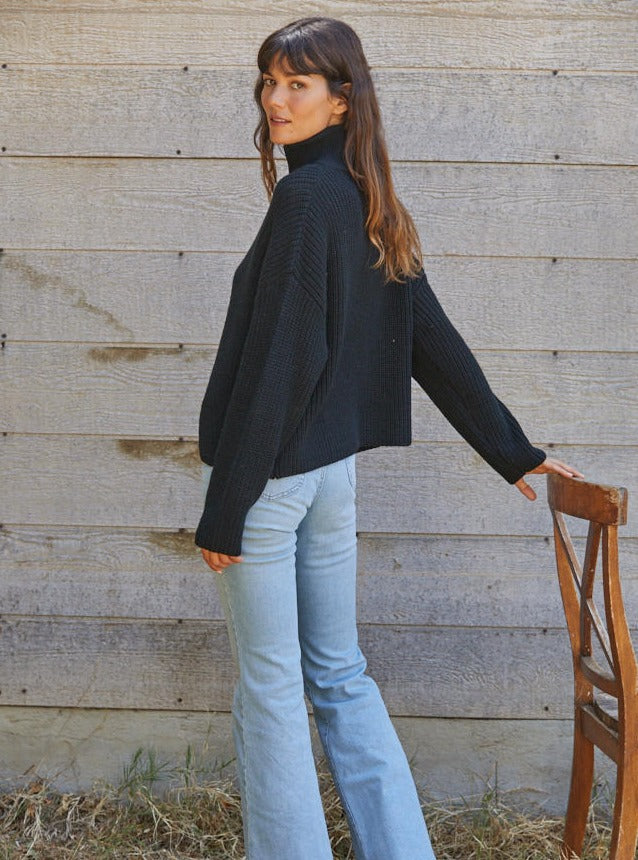 On The Boardwalk Sweater  Knitted Sweater Quarter zip Turtleneck Specs/dimensions: HPS Length: (S) 20 1/4", (M) 20 3/4", (L) 21 1/4" Chest: (S) 21 1/4", (M) 22 1/4", (L) 23 1/4" Sweep: (S) 20 3/4", (M) 21 3/4", (L) 22 3/4" Sleeve Length: (S) 17", (M) 17 1/4", (L) 17 1/2" 94% Acrylic, 6% Nylon Color: Black Stay warm and stylish in this quarter zip sweater. Its soft, lightweight fabric makes it ideal for breezy beach days, while th