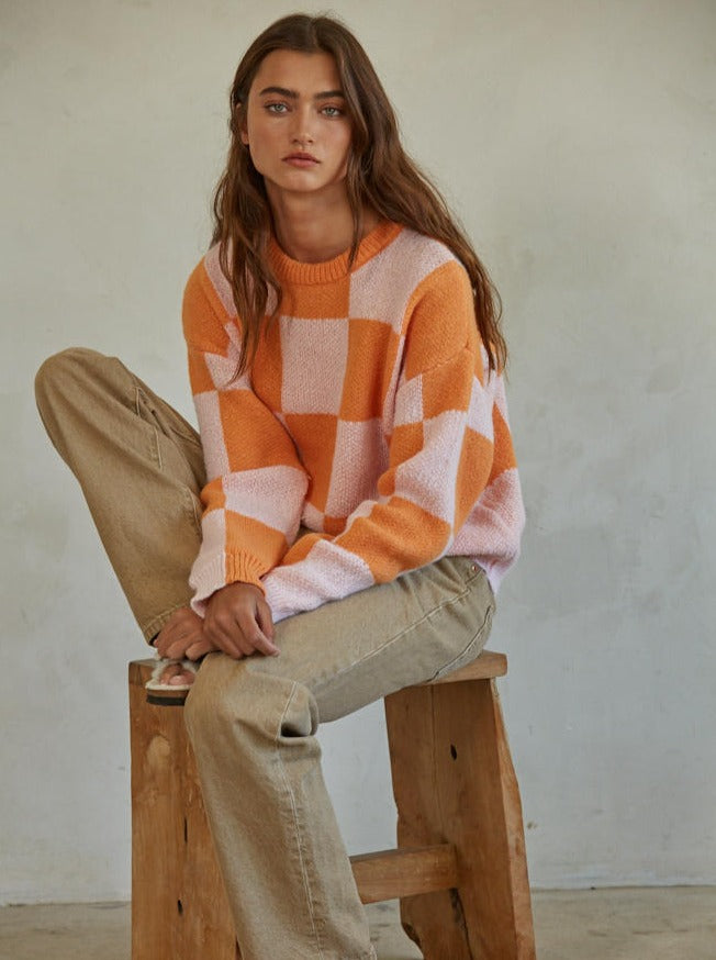 Call You Mine Pullover  Knit Polyester Sweater Gingham Print Crew Neck Long Sleeve Pullover Top 100% Polyester Color: Orange This Call You Mine Pullover features a timeless checkered print design. Crafted with quality materials and stitching, this cardigan is sure to deliver comfort and style for years to come. Add a classic touch to your wardrobe with this stylish cardigan.