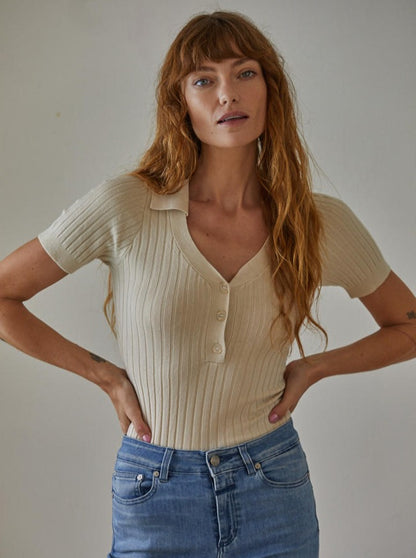 Call Me Maybe Top  Knit Viscose Spandex Sweater Ribbed Button down Collar V-Neck Short Sleeve Pullover Top 75% Viscose, 25% Spandex Color: Tan Be sophisticated and stylish with the Call Me Maybe Top from our new collection. Crafted from a soft, breathable material, this short sleeve button down sweater top is perfect for any occasion. With its comfortable fit and classic design, you're sure to stand out in any room.