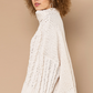 Turtle Neck Cable Knit Sweater Designed in an oversize body Turtle neck long sleeve in chenille with cable knitting Pullover sweater Specs/dimensions: - Bust: 30" - Length: 20-1/2" - Sleeve: 17-1/2" - Shoulder: 29-1/2" 100% Polyester Color: Powder Cream