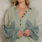 Highlands Thermal Button Up Top   Oversize Top Contrast Thermal Sleeve Button Up Gauze Shirt Placket collar shirt Balloon sleeve details Relaxed fit Featured in double gauze and thermal mix Specs/dimensions: - Length (front): 24" - Length (back): 27" - Bust: 25"  100% Cotton The Highlands Thermal Button Up Top is an effortless way to sport style and comfort. With an oversize fit, contrast thermal sleeve, and button-up gauze shirt, this top offers functionality as well as a unique design.