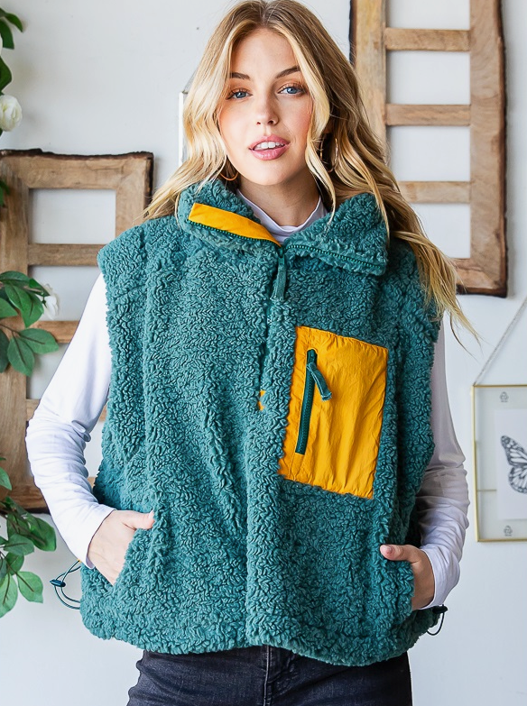 Sherpa Half Zip Vest  Sherpa Half Zip Relaxed Fit Pocket Details  Vest Color: Green Stay warm and cozy in any weather with the Sherpa Half Zip Vest. This cozy sherpa vest is made from a lightweight, breathable fabric and features a half zipper closure for adjustable comfort and warmth. The vest traps heat to keep you toasty all day long.