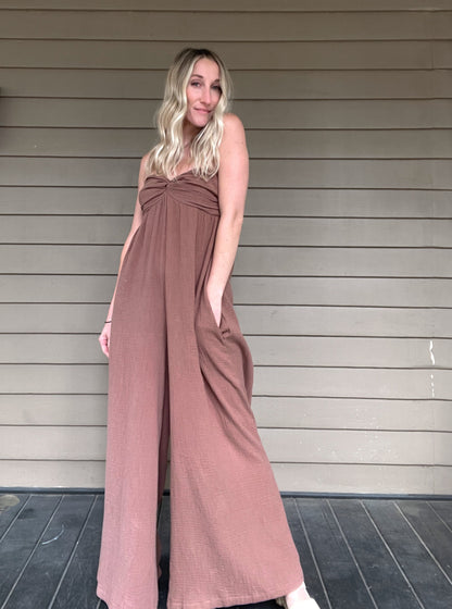 Moroccan Strapless Jumpsuit - Mocha  Wide leg strapless jumpsuit Twisted bust Wide leg Pockets 100% Cotton Color: Mocha Step out in style with this Moroccan Strapless Jumpsuit. This wide leg boho jumpsuit provides elegance and comfort. Crafted from quality materials, this jumpsuit will make a statement while keeping you comfortable throughout the day. Perfect for any special occasion.