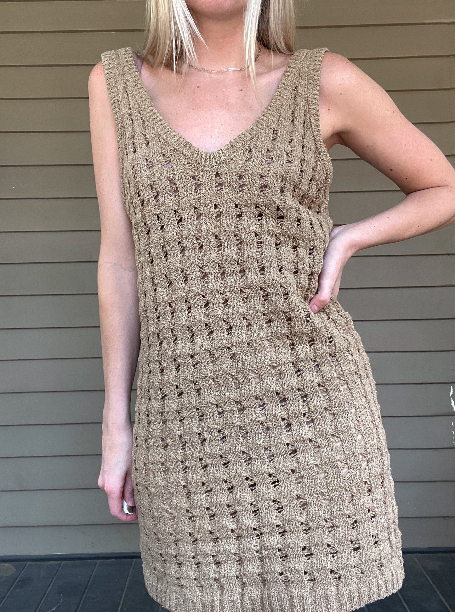 By The Sea Crochet Mini Dress  Crochet Knitted Dress 67% Acrylic, 33% Nylon Color: Mocha The By The Sea Crochet Mini Dress is perfect to layer on over your favorite bikini. Crafted with lightweight, breathable crochet, this dress is perfect for hot days in the sun. Effortlessly throw it on for a day in the sand or a night out.