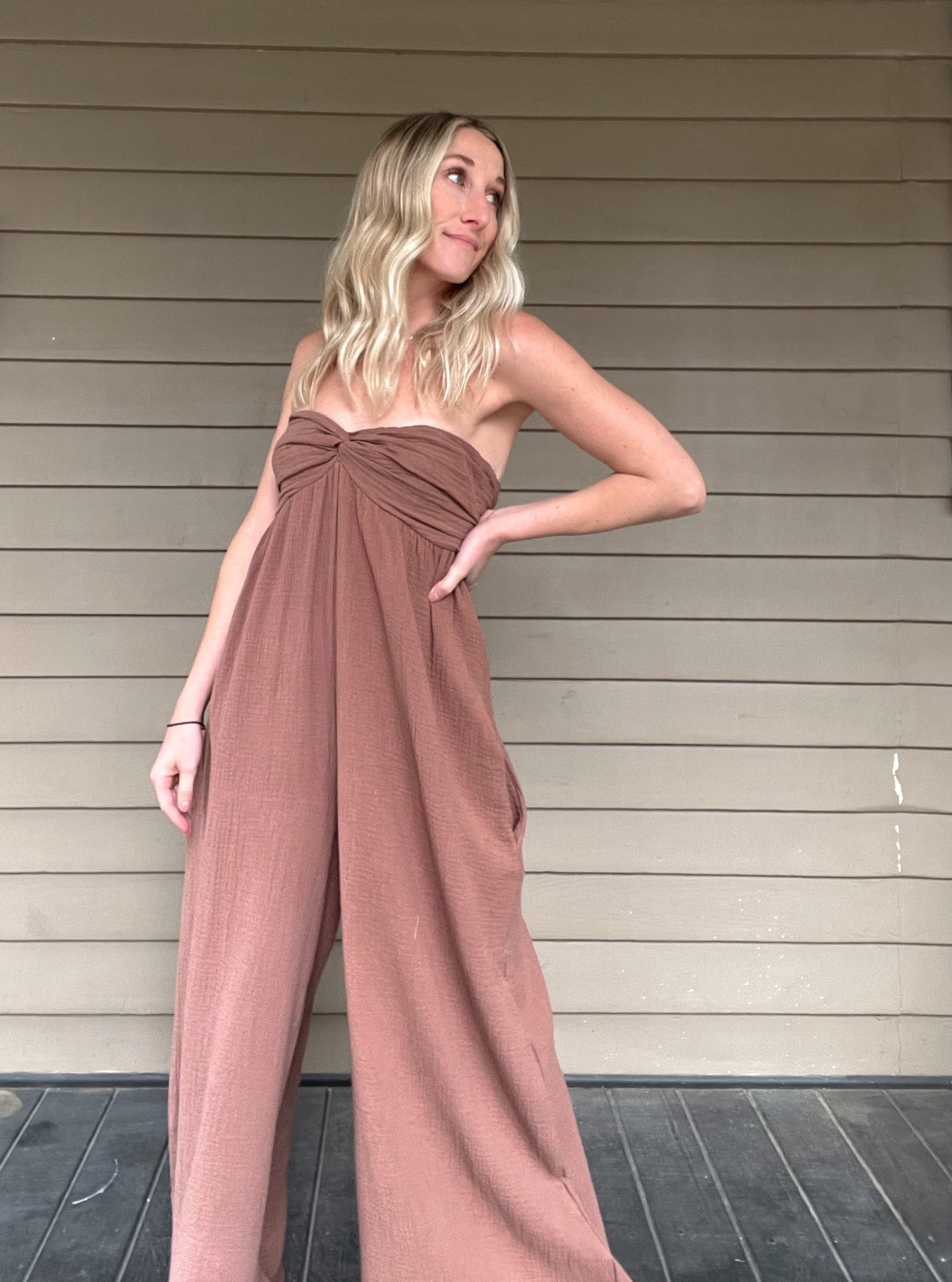 Moroccan Strapless Jumpsuit - Mocha  Wide leg strapless jumpsuit Twisted bust Wide leg Pockets 100% Cotton Color: Mocha Step out in style with this Moroccan Strapless Jumpsuit. This wide leg boho jumpsuit provides elegance and comfort. Crafted from quality materials, this jumpsuit will make a statement while keeping you comfortable throughout the day. Perfect for any special occasion.