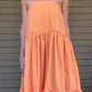Twisted adjustable spaghetti strap tube crop top  Smocked back Flared ruffle tier maxi skirt Skirt has side invisible zipper Use skirt and wear it as a strapless tiered ruffle dress 100% Cotton Color: Orange This oversized romper is perfect for those cozy days or balmy summer nights. Made from premium material, this lightweight romper offers a breathable yet comfortable fit that won't weigh you down. Perfect with a pair of sandals or sneakers, this romper is sure to be a summer staple.