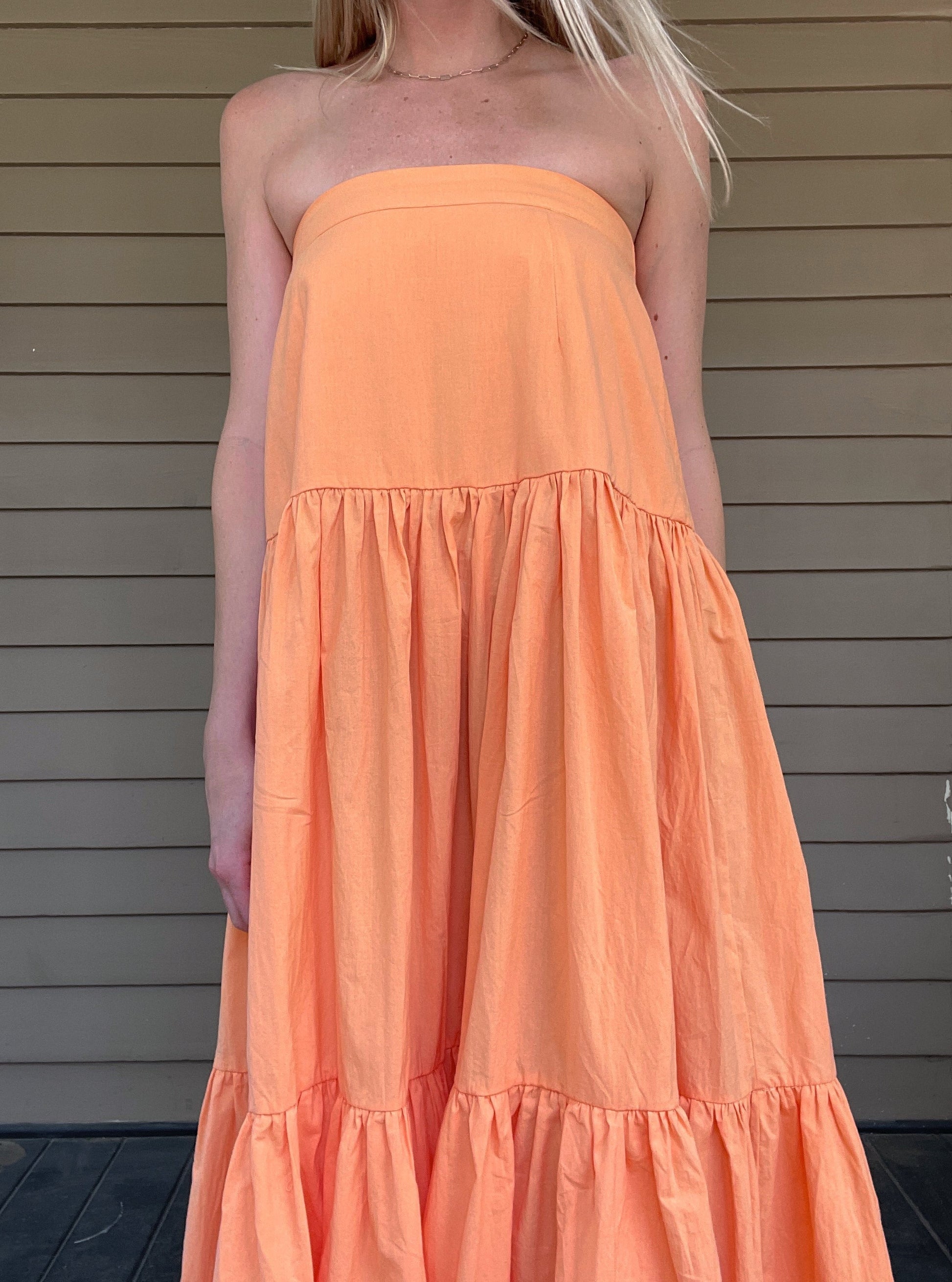 Twisted adjustable spaghetti strap tube crop top  Smocked back Flared ruffle tier maxi skirt Skirt has side invisible zipper Use skirt and wear it as a strapless tiered ruffle dress 100% Cotton Color: Orange This oversized romper is perfect for those cozy days or balmy summer nights. Made from premium material, this lightweight romper offers a breathable yet comfortable fit that won't weigh you down. Perfect with a pair of sandals or sneakers, this romper is sure to be a summer staple.